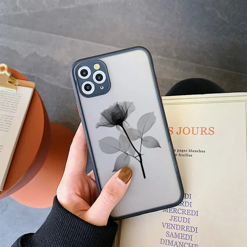 a woman holding a phone case with a flower on it
