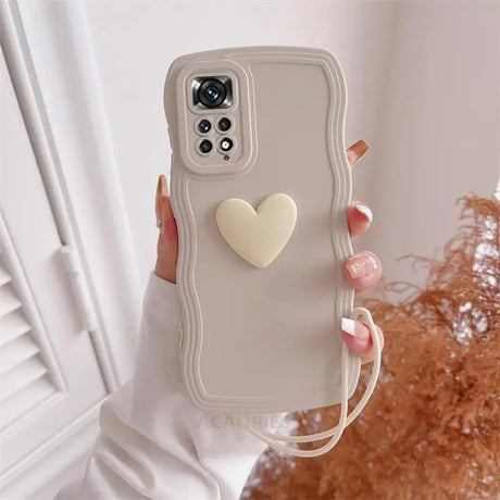 a woman holding a phone case with a heart on it