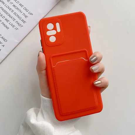 a woman holding a red phone case