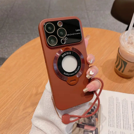 a woman holding a red phone case with a camera attached to it