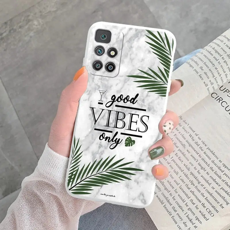 a woman holding a phone case with the words good vibe on it