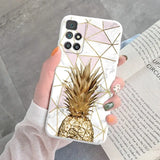 a woman holding a phone case with a pineapple on it