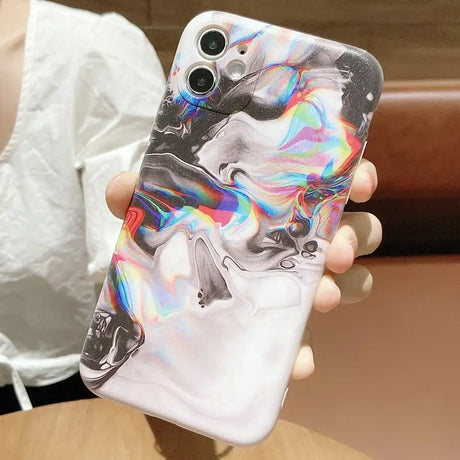 a woman holding a phone case with a marble marble pattern