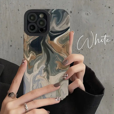 a woman holding a phone case with a marble pattern