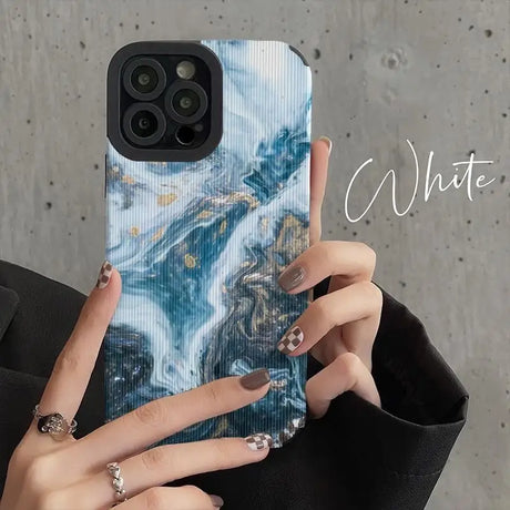 a woman holding a phone case with a marble pattern