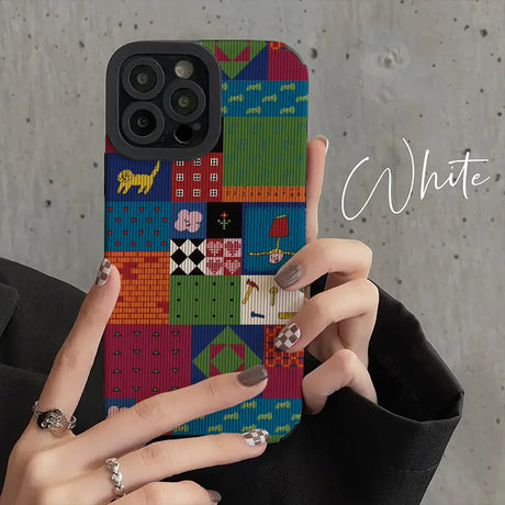 a woman holding a phone case with a colorful pattern