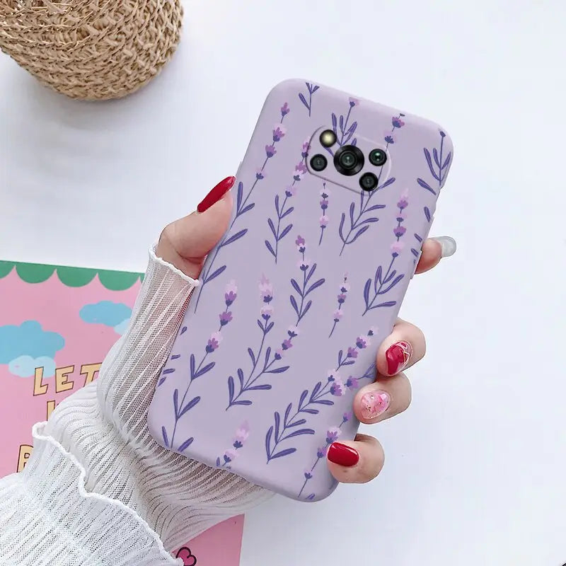 a woman holding a phone case with purple flowers on it