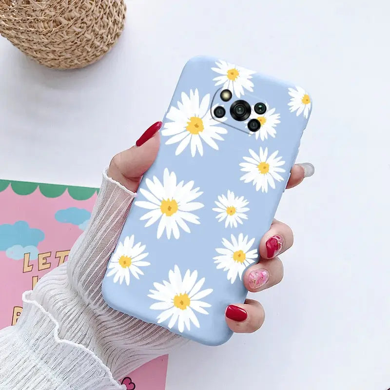 someone holding a phone case with a daisy pattern on it