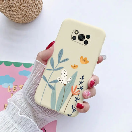 a woman holding a phone case with a flower design