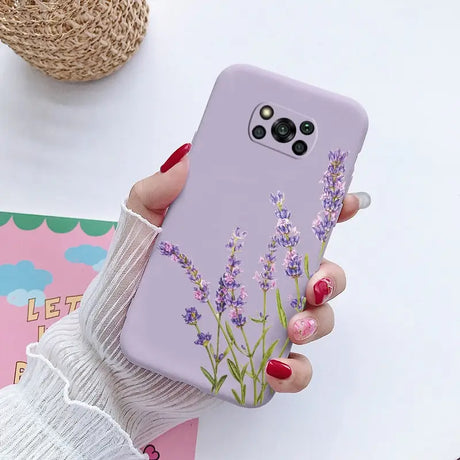 a woman holding a phone case with lavender flowers on it