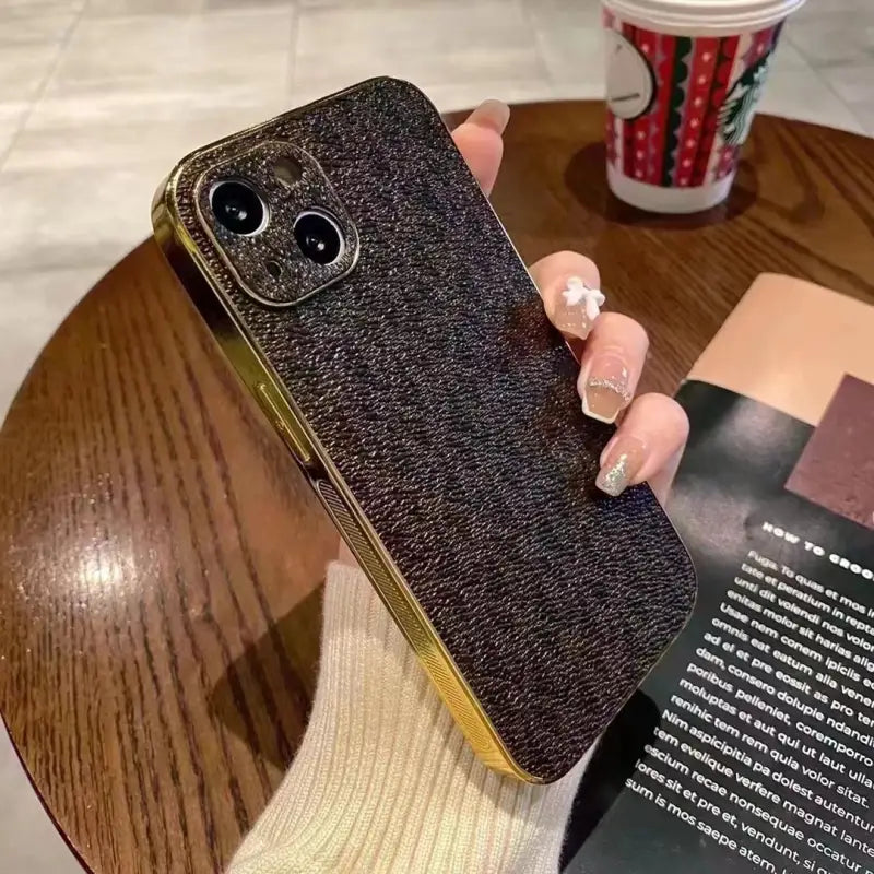 a woman holding a phone case with a book