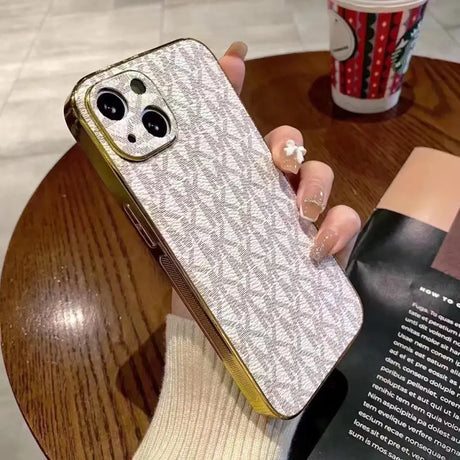 a woman holding a phone case with a book