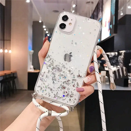 a woman holding a phone case with glitter