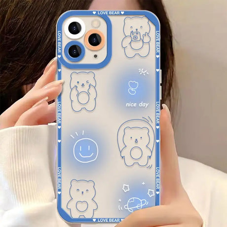 a woman holding a phone case with a blue bear pattern