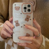 a woman holding a phone case with a bear design