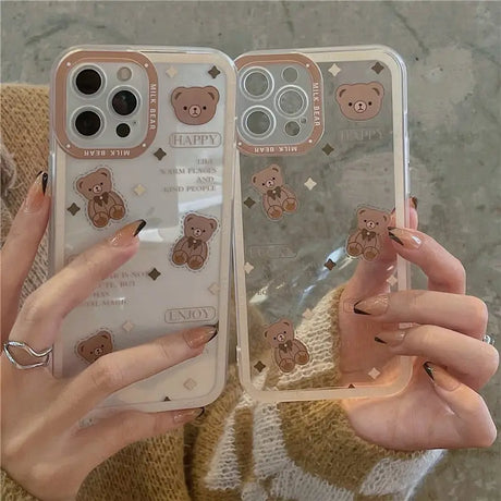 a woman holding a phone case with a bear design