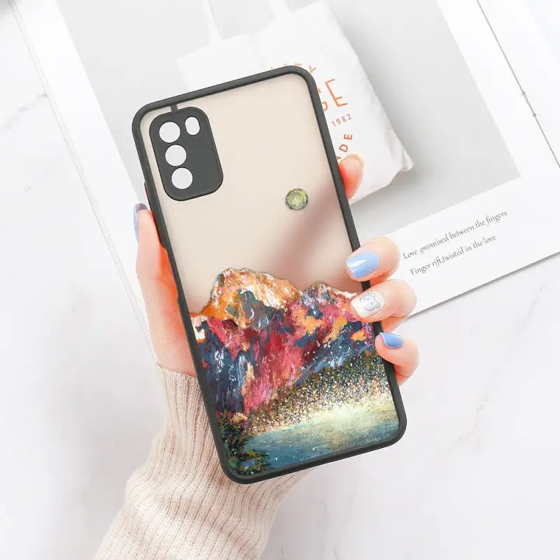 a woman holding a phone case with a painting on it