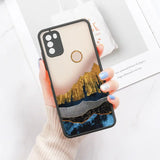 a woman holding a phone case with a mountain scene