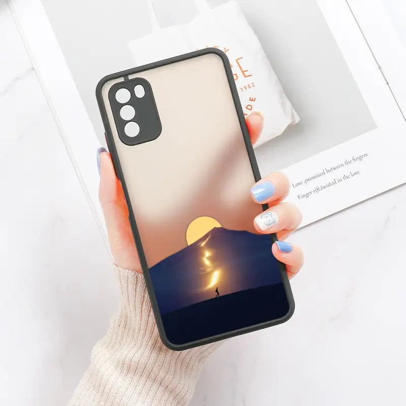 a woman holding a phone case with a candle in the background