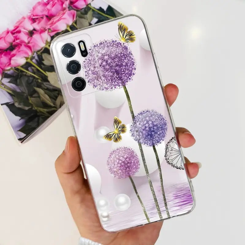 a woman holding a phone case with purple flowers