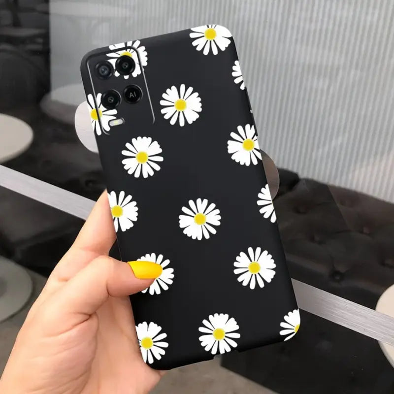 a person holding a phone case with a daisy pattern on it