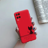 a hand holding a red phone case with a cat on it