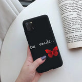 a woman holding a phone case with a red bow on it