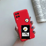 a woman holding a red phone case with a daisy on it