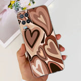 a woman holding a phone case with a heart pattern