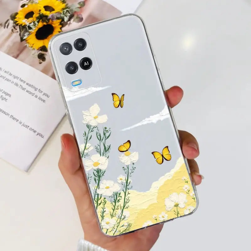 a woman holding a phone case with flowers and butterflies