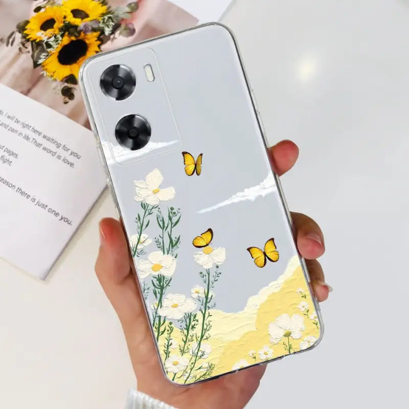 a woman holding a phone case with a yellow butterfly on it