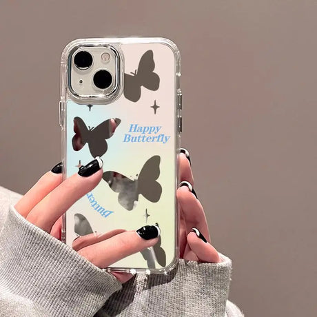 a woman holding a phone case with butterflies on it