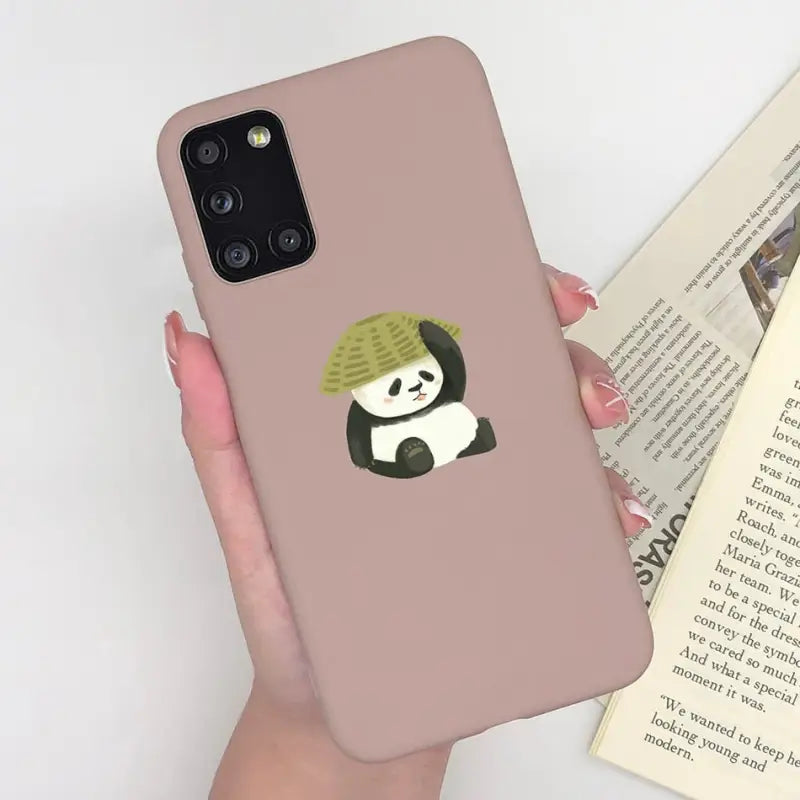 a woman holding a phone case with a panda bear on it