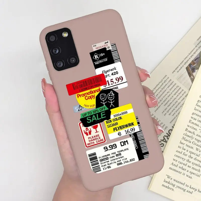 a person holding a phone case with a book
