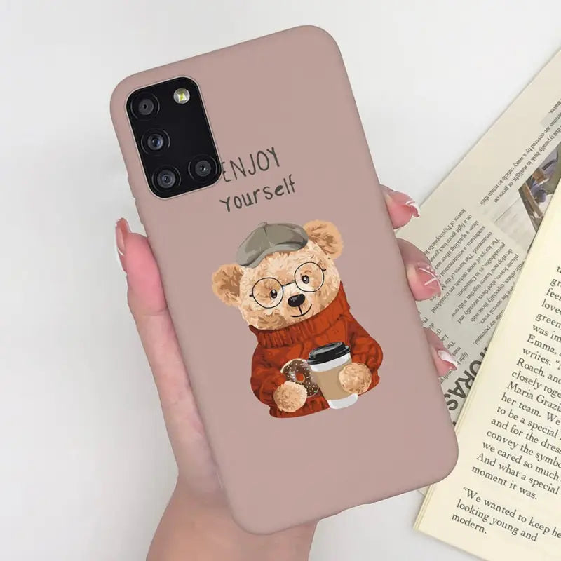 a woman holding a phone case with a bear