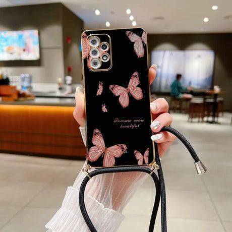 a woman holding a phone case with butterflies on it