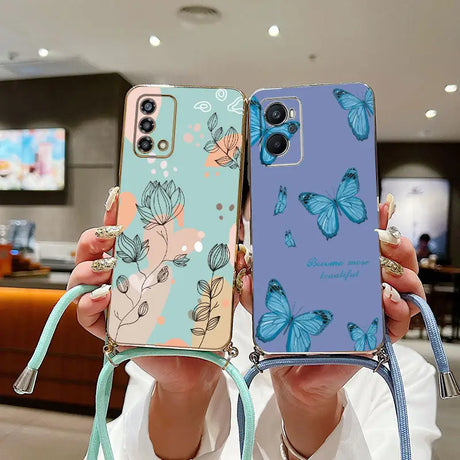 a woman holding up a phone case with butterflies on it