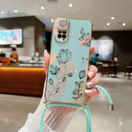 a woman holding a phone case with a flower pattern