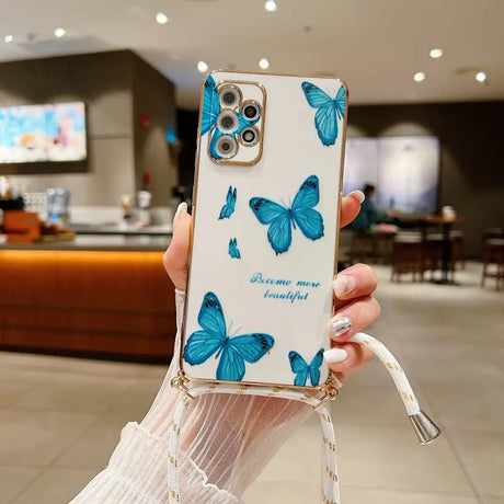 a woman holding a phone case with blue butterflies on it