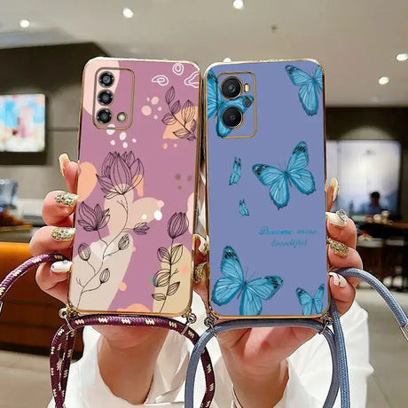 a woman holding up a phone case with butterflies on it