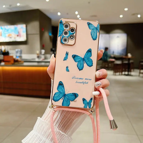 a woman holding a phone case with blue butterflies on it