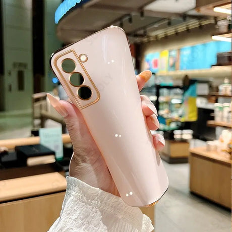 a woman holding a pink phone case