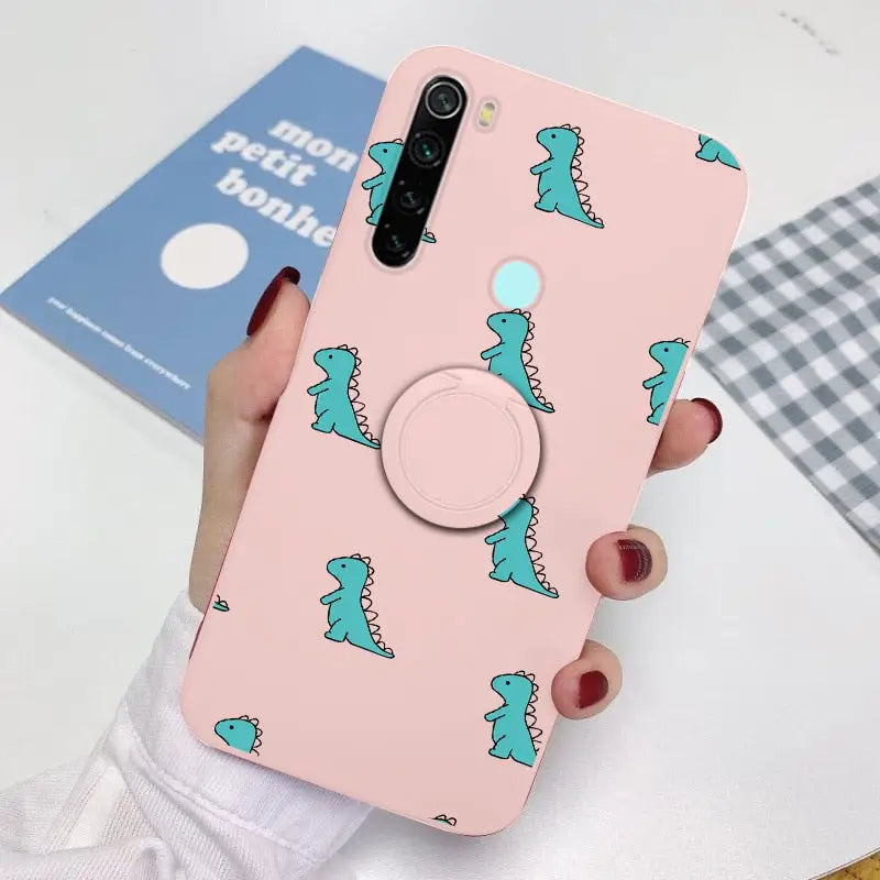 a woman holding a phone case with a dinosaur pattern