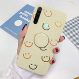 a woman holding a phone case with a smiley face