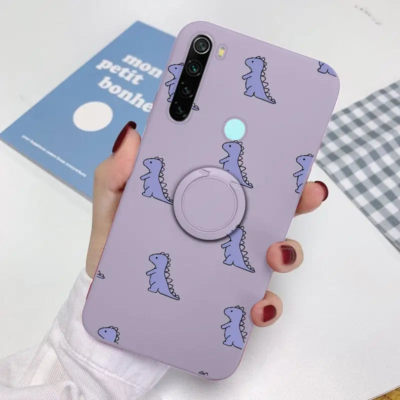 a woman holding a phone case with a purple dinosaur pattern