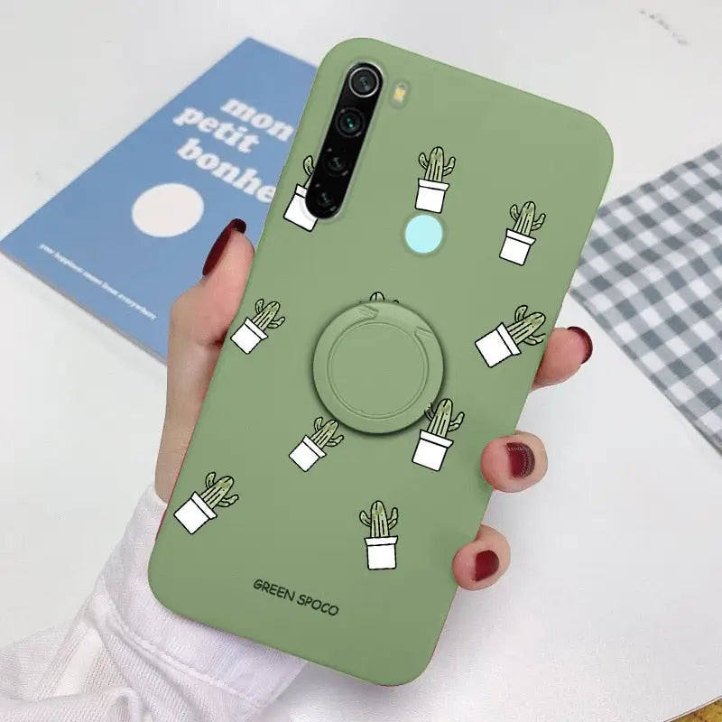 a woman holding a phone case with cactus design