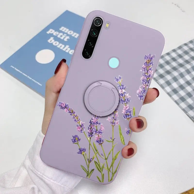 a woman holding a phone case with lavender flowers