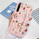 a woman holding a phone case with flowers on it