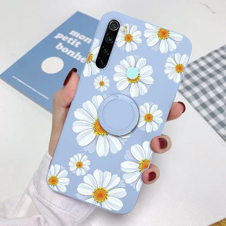 a woman holding a phone case with a flower pattern