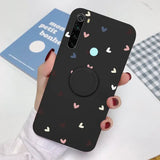 a woman holding a phone case with hearts on it